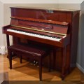 M01. Pearl River upright piano with polished mahogany finish. Model UP118E. 